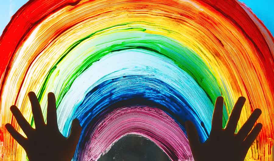 Kid finger painting rainbow