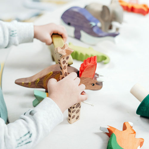 kid with wooden toys